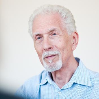 Harvey Burns smiling, portrait photo.